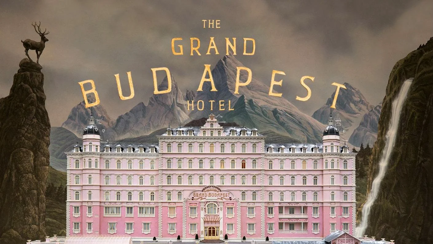 The Grand Budapest Hotel title card, its gold lettering set across the mountains above the hotel